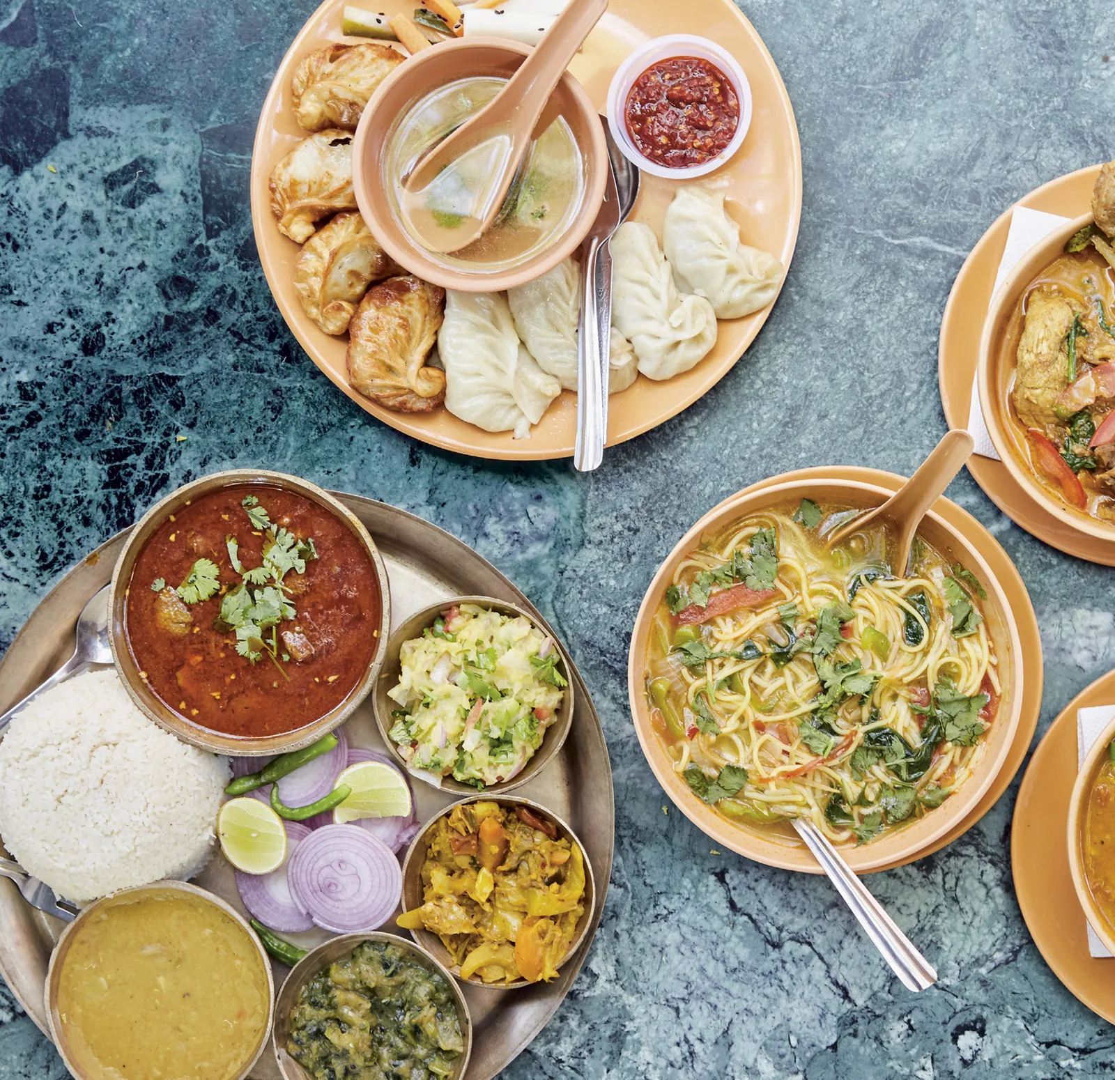 Stock photograph of Indian and Nepali dishes arranged across a table